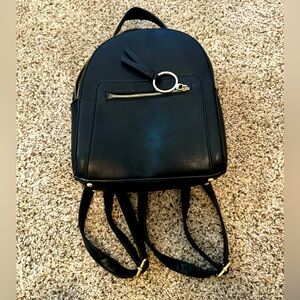 Mini backpack black w/ gold color. Minor flaws. Great cond. Adjustable straps.